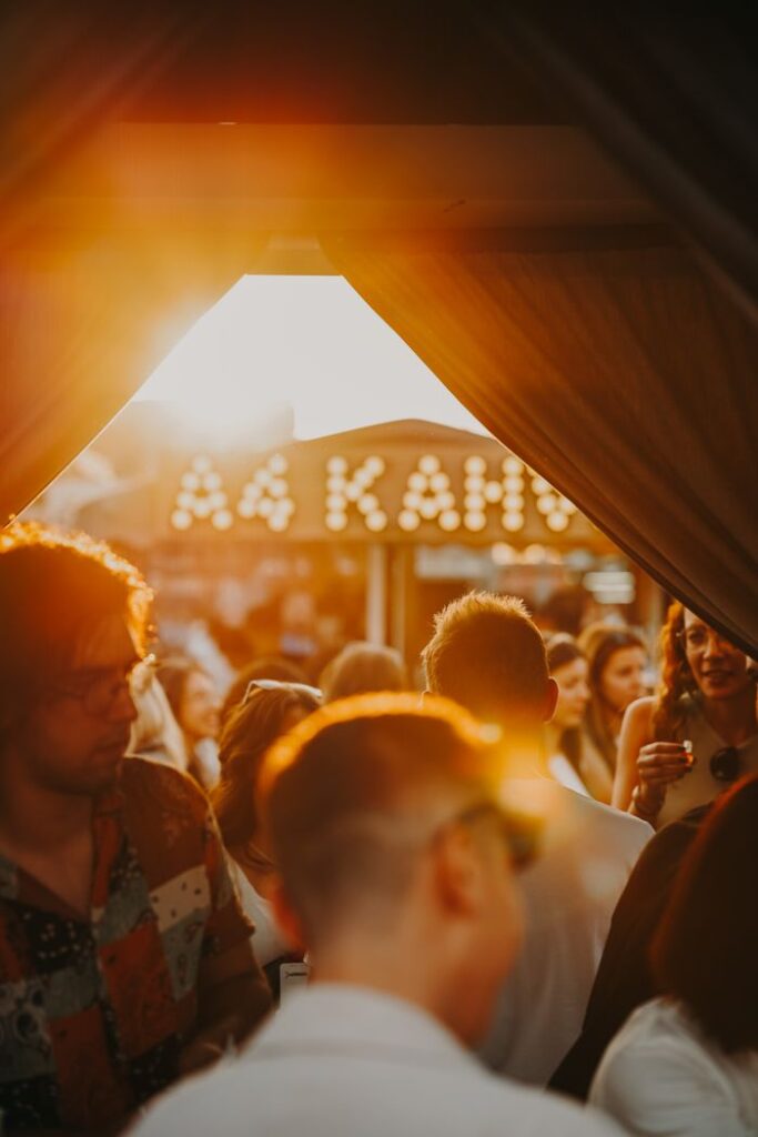 A lively crowd enjoys an evening event in Ankara, Türkiye under a warm sunset glow.